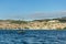 Little sailboat sailing the sea in front of the city of Sibenik .