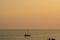Little sailing boat on the ocean with amazin orange soft color sunset corfu, greece