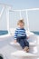 Little sailor on boat. summer vacation. childhood happiness. sailor kid in striped marine shirt. traveling adventures