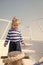 Little sailor kid on boat. funny kid in striped marine shirt. traveling adventures and wanderlust. summer vacation