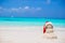 Little sandy snowman with red Santa Hat on white