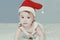 Little Santa. 1-year-old baby girl in Santa Claus hat. Merry Christmas. Adorable middle-eastern girl in Santa cap
