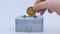 Little saving vault, hand holds golden Ethereum, ETH coin virtual money. Cryptocurrency, business and saving concept