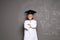 Little school child in laboratory uniform with graduate cap