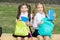 Little school friends girls with backpacks, sincere happiness concept