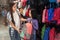 Little school girl with mother choosing backpack