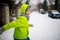 Little schoolboy goes down the street in winter day.