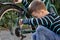 Little schoolboy repair bicycle