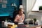 Little schoolchild sitting at desk table in living room doing mathematics homework