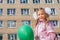 Little schoolgirl with green balloon