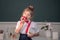 Little schoolgirl pupil student in class, eating apple at school. Back to school.