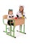 Little schoolgirls sitting at a desk