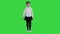 Little serious girl walking towards camera on a Green Screen, Chroma Key.