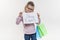 Little shop specialist, child girl with shopping bags holding a white sheet of paper with the text shop expert, white background