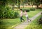 Little sibling boy playing plane paper in the park outdoor