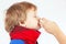 Little sick boy used nasal spray in the nose