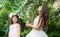 Little sisters adorable white dresses wedding party in park, natural beauty concept