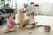 little sisters reading books with golden retriever dog near