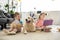 little sisters reading books with golden retriever dog near