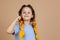 Little smart girl with kanekalon braids of yellow color showing finger having aha moment because of great idea appearing