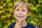 Little smiling child boy hand pointing his first baby milk or temporary tooth fall out