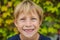 Little smiling child boy hand pointing his first baby milk or temporary tooth fall out