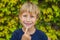 Little smiling child boy hand pointing his first baby milk or temporary tooth fall out