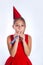 Little smiling funny girl with birthday hat and whistle on white background.