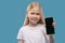 Little smiling girl showing smartphone screen