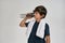 Little sportive boy child in sportswear drinking water from the bottle while standing with white towel around his neck