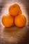 Little stack of orange fruits on wooden desk