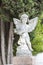 Little stone angel on a tomb or grave in a churchyard