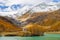 Little stone house on the islet of the Palu Lake below Piz Palu glacier in Swiss Alps