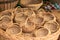 Little straw woven baskets in a large basket. Souvenirs from straw