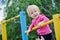 Little strong baby girl playing sports outdoor. Child with his d