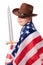 Little strong girl in cowboy hat with american flag and sword.