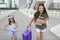 Little student girls going to school in city