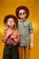 little stylish cowboy and cowgirl posing in hats,