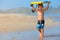 Little surfer run with bodyboard on sea beach