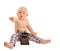 Little surprised baby boy with outstretched hand with coffee grinder wearing plaid pants