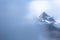 Little Tahoma Peak viewed through the fog along the Wonderland Trail of Mount Rainier National Park