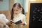 Little teacher. Beautiful young girl is teaching toys at home on blackboard.