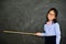 Little teacher using stick pointing chalkboard