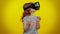 Little teen child kid girl using virtual reality VR app headset helmet to play simulation 3D game