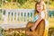 Little teen girl musician playing guitar. Dreamy kids face. Smiling child playing outdoors in summer.