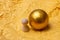 Little tiny wooden person figurine and gold color ball