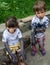 Little toddler boy and girl with dirty face and dirty clothes on nature