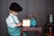 Little toddler boy, playing with mill at home, sitting on vintage table