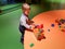 Little toddler boy playing with plastic toy bricks in amusement park children center