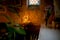 Little toddler boy, praying in chapel with candles in front